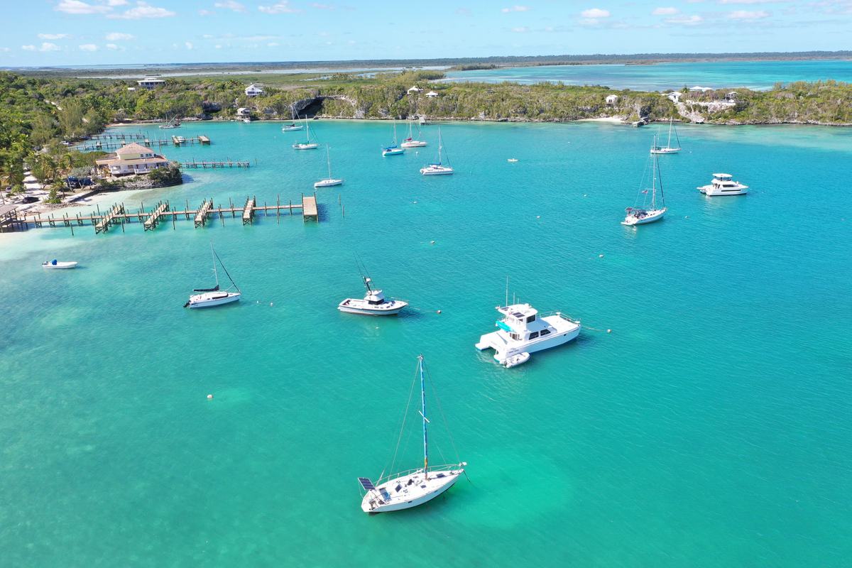 Sandy Bahamian beach with a Bahamas sign and a boat