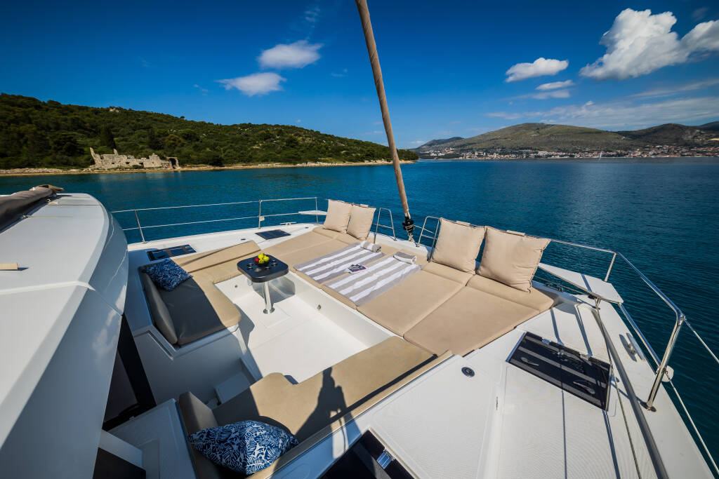 The forward lounge deck of the BALI 4.8 with loungers and a bay view