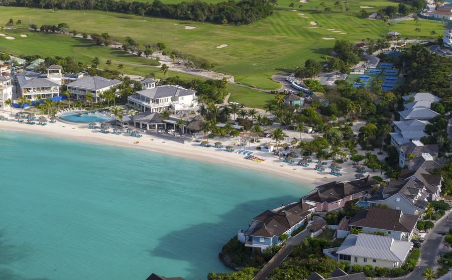 The Abaco Club's clubhouse and pool with the golf course in the background