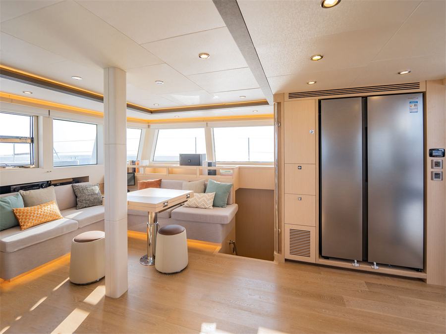 The saloon with dining area and galley on the SeaView 50