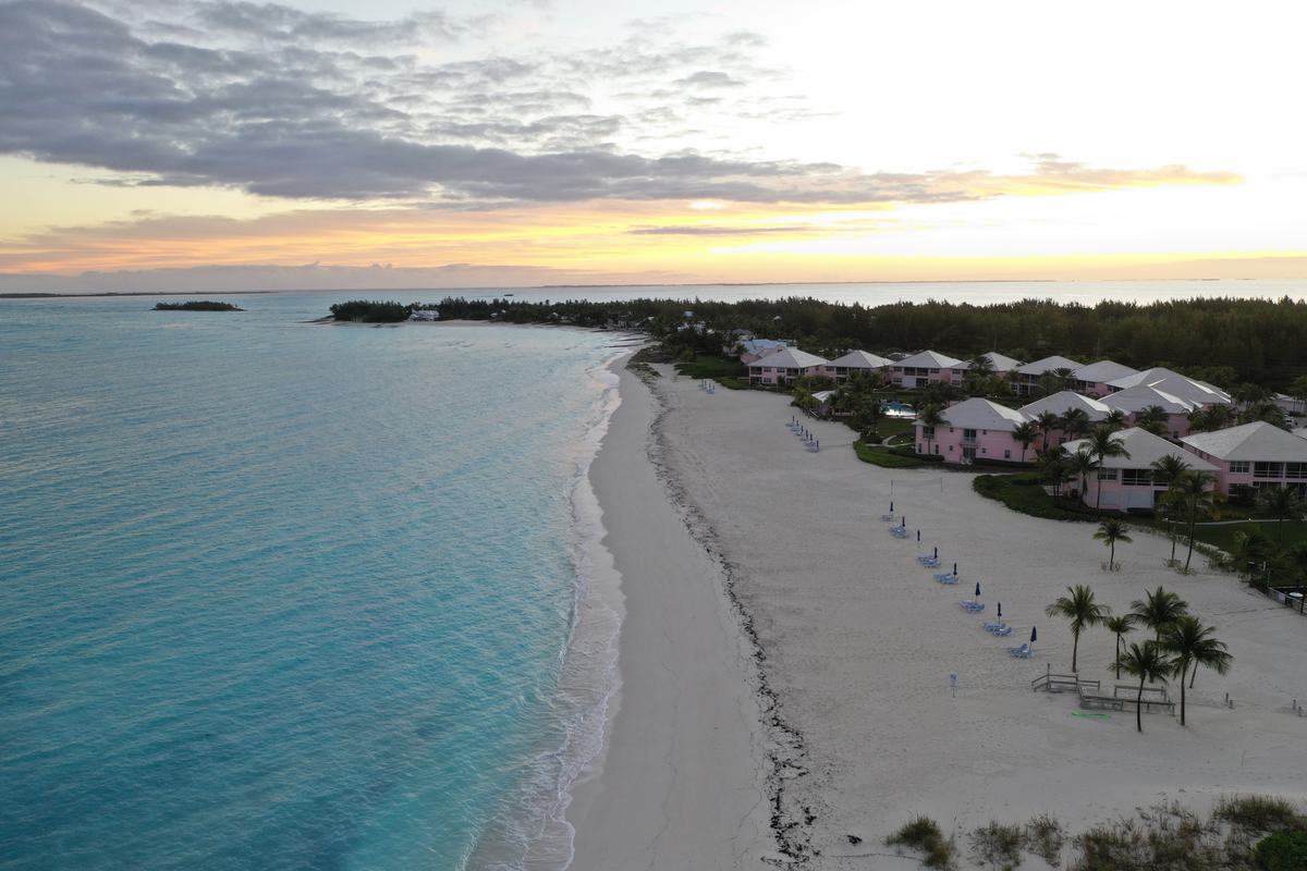 Sunset over a beach with cottages in Abaco